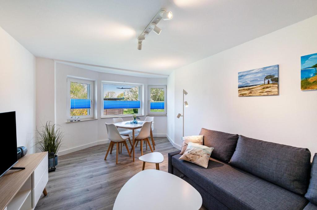 a living room with a couch and a table at Strandnahe Fewo 1 in Dierhagen