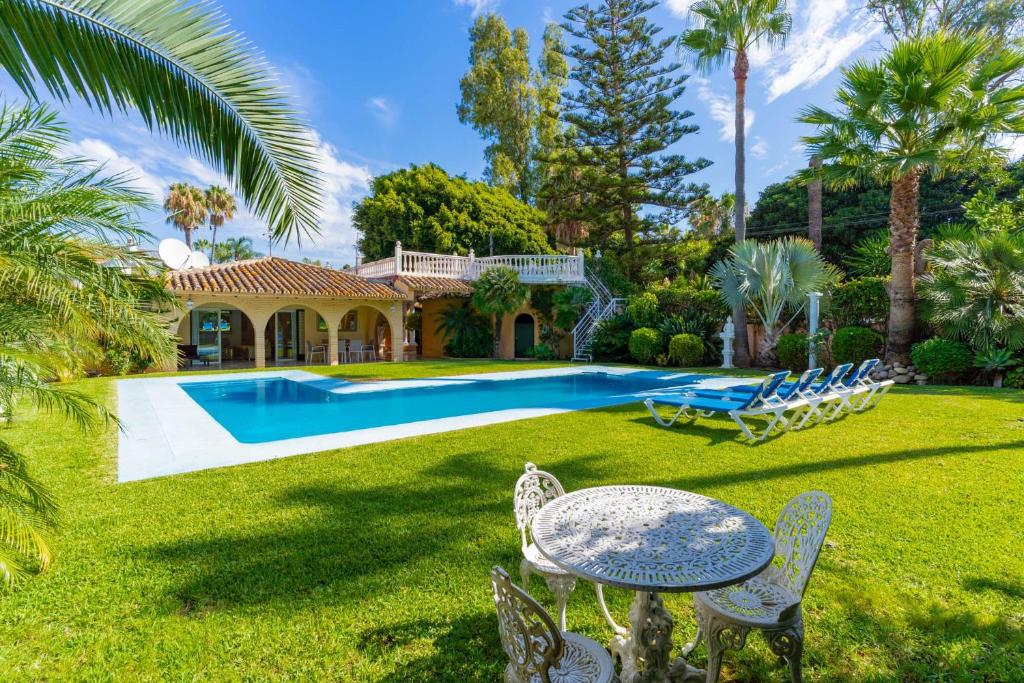 a backyard with a pool and a house at Exclusive Villa El Messidor in Marbella