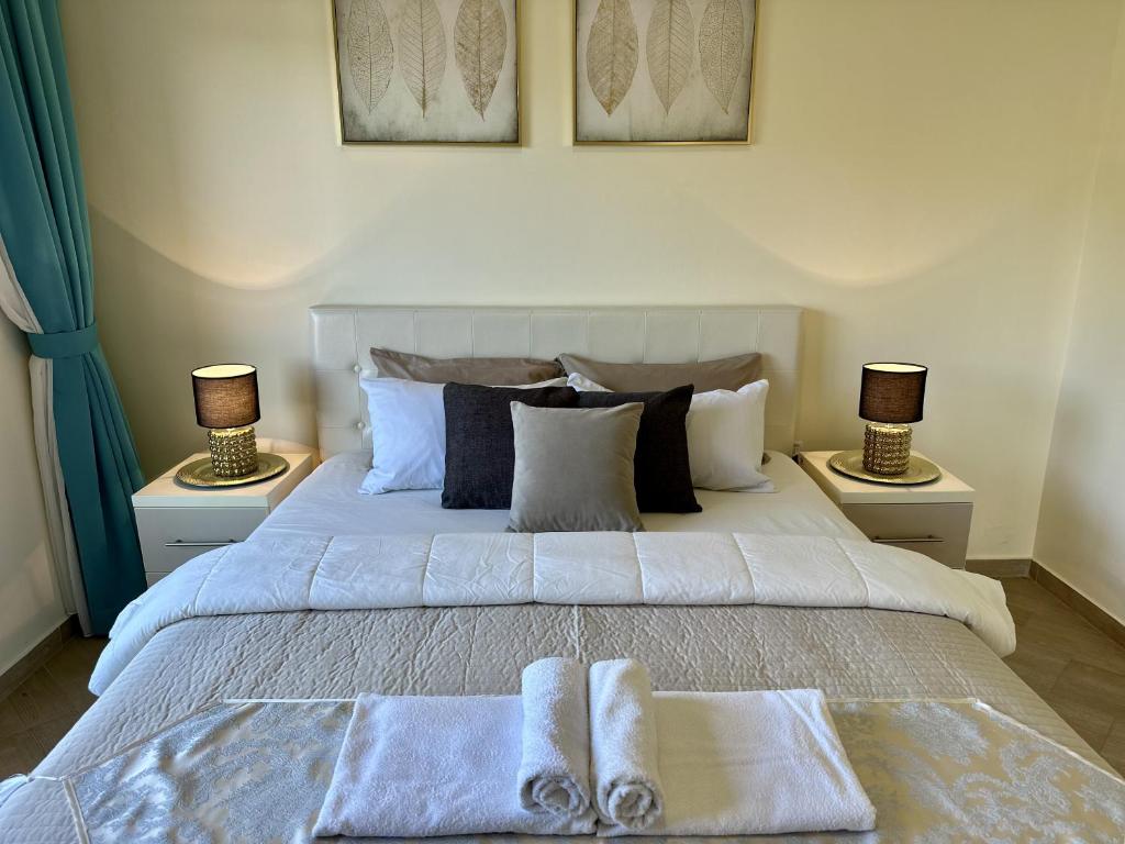 a bedroom with a large bed with towels on it at EDEM free parking, sea view & pool in Kunje