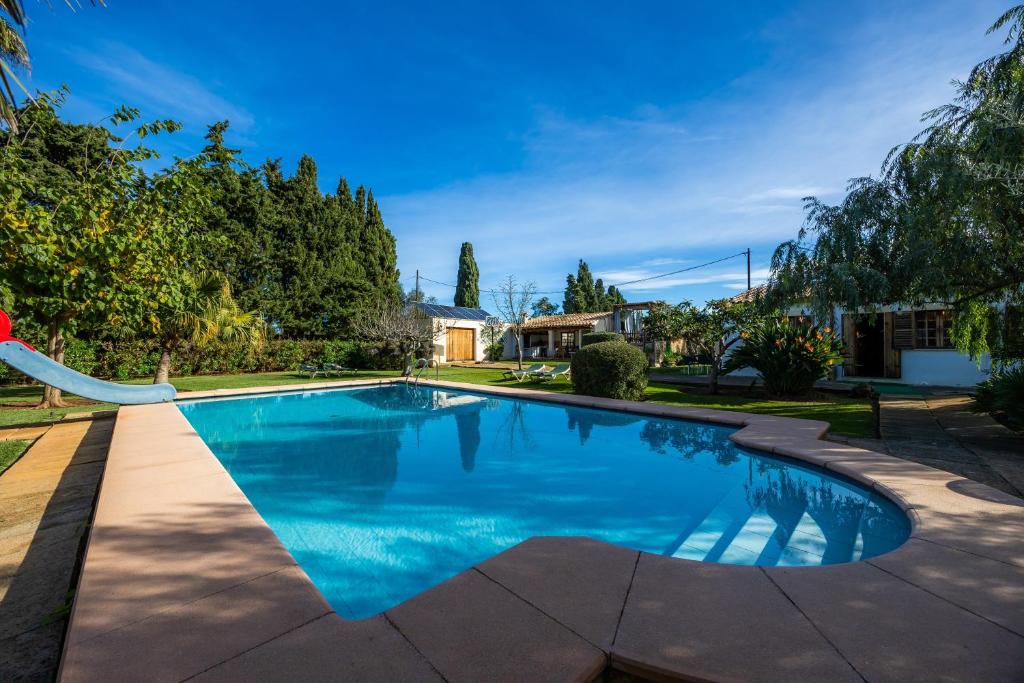 a swimming pool in a yard with trees at Can Bleo in Pollença