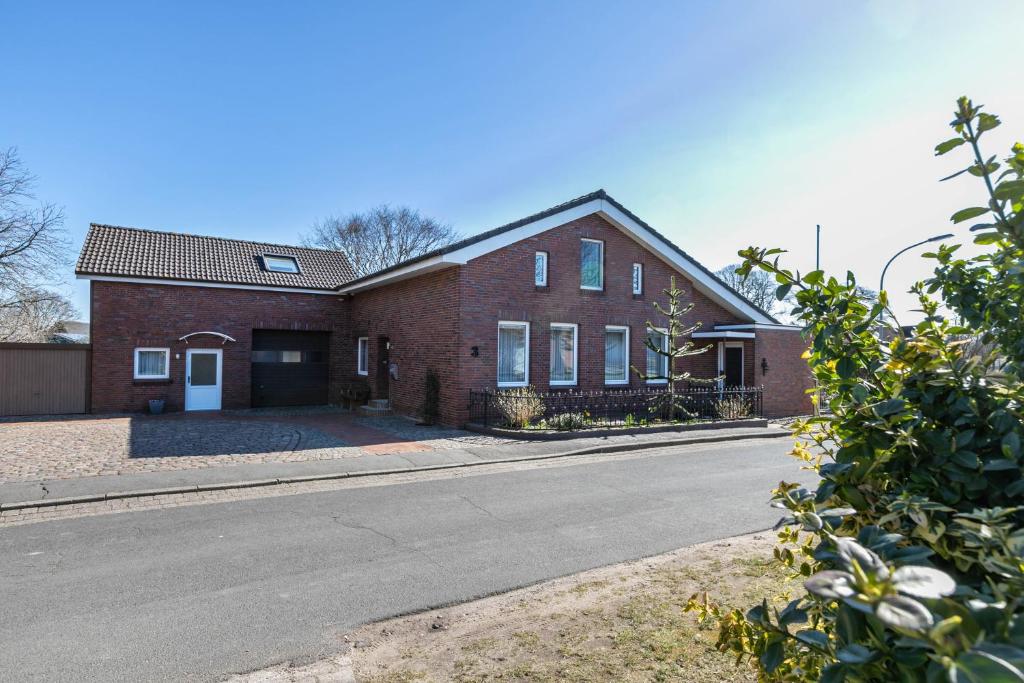 a red brick house with a road in front of it at Alte Schmiede in Kuden