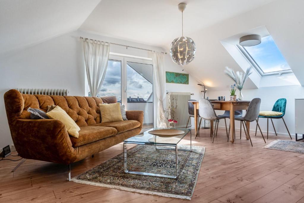 a living room with a brown couch and a table at Ferienwohnung Romanu in Winzeln