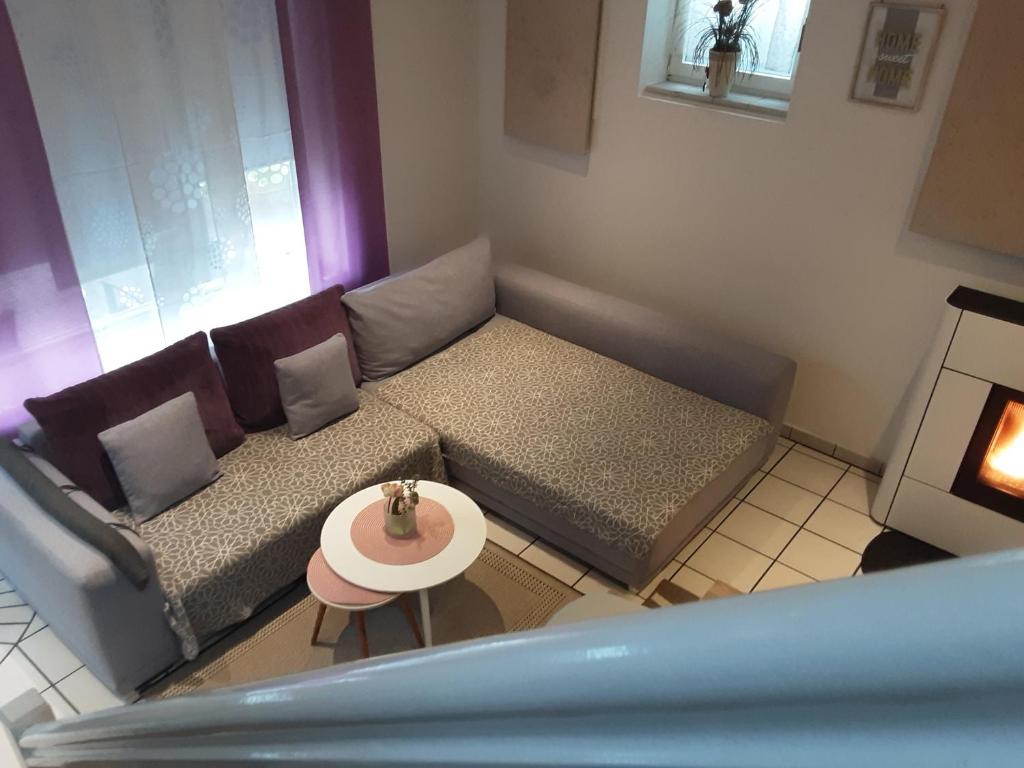 a living room with a couch and a table at Garten der Ruhe in Osterbuch