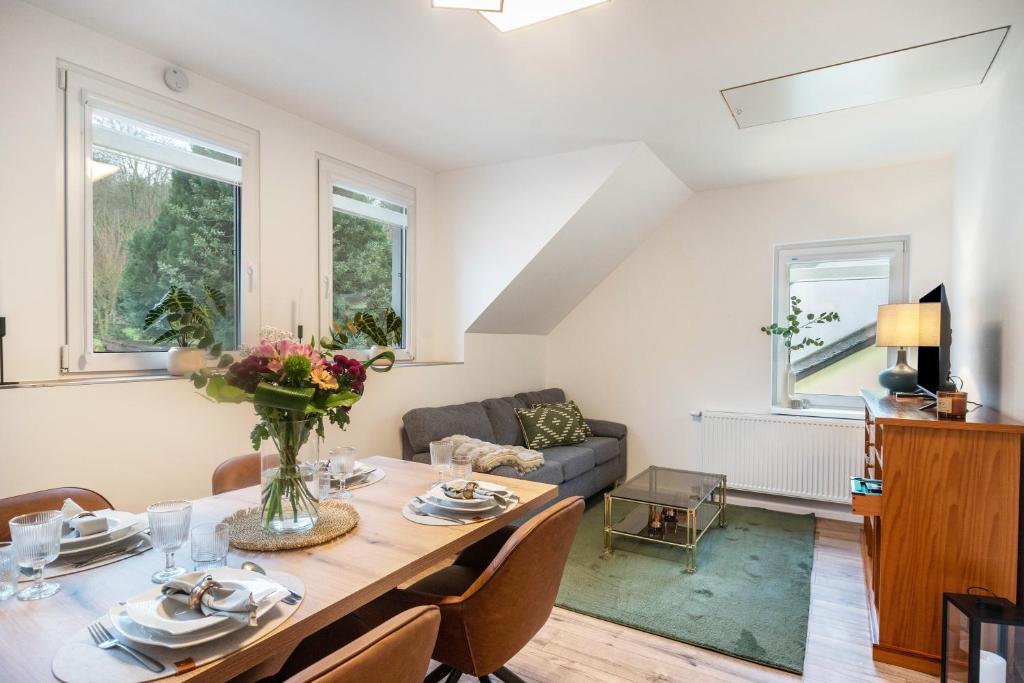 a living room with a table and a couch at Ferienwohnung Maxim in Saarburg