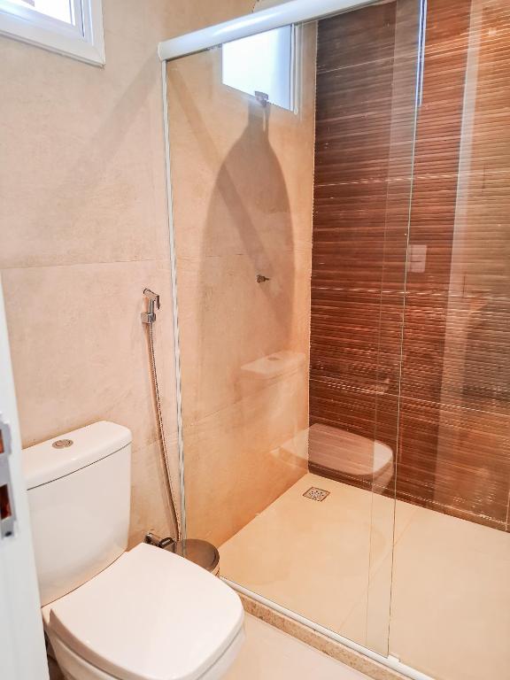 a bathroom with a toilet and a glass shower at Quinta da Praia in Serra