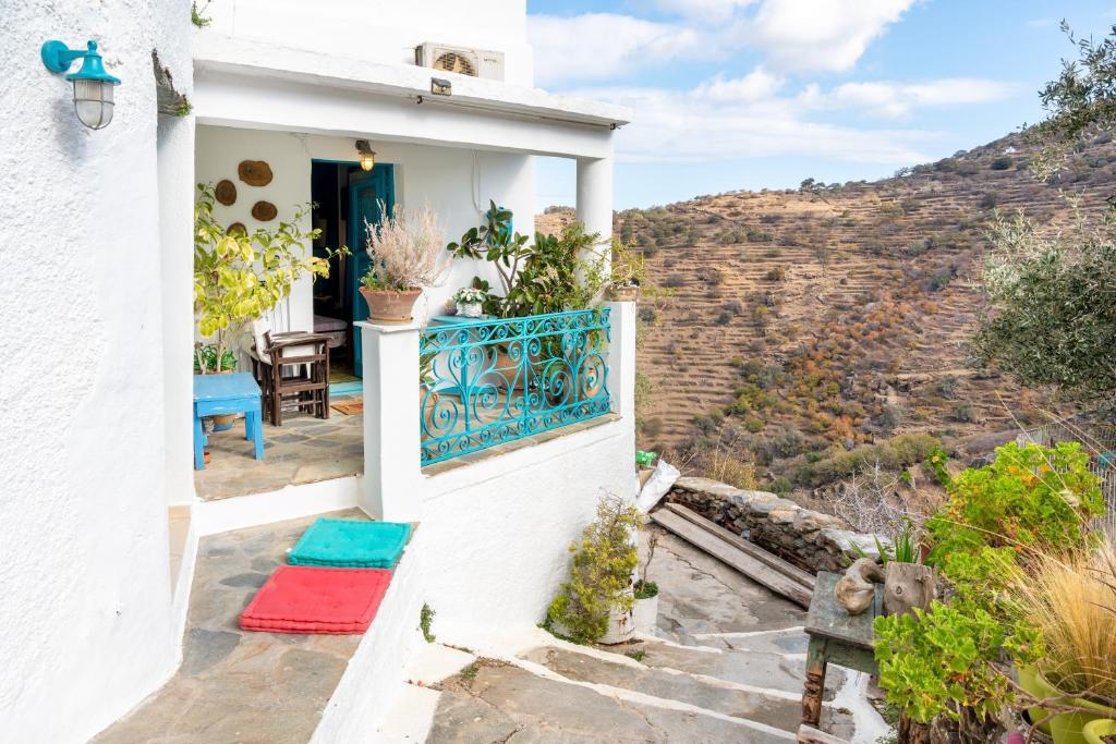 a white house with a balcony with a view at The Castle House Kea in Ioulis