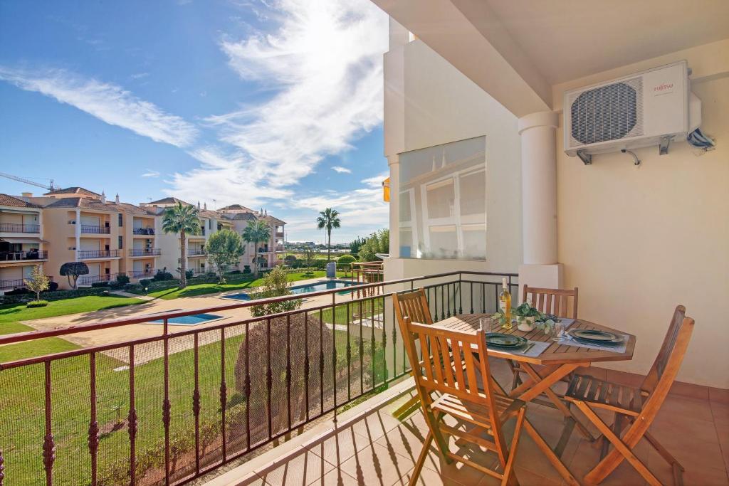 a balcony with a table and chairs and a view at Cosy Apartment with Pool 1 in Vilamoura