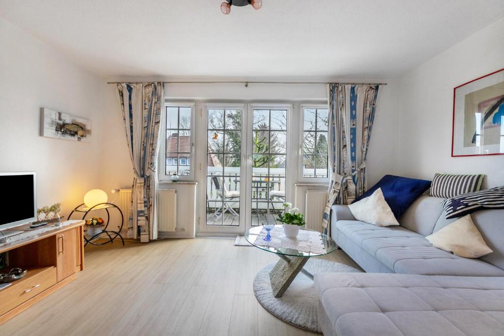 a living room with a couch and a tv at Erholung Pur in Hennstedt
