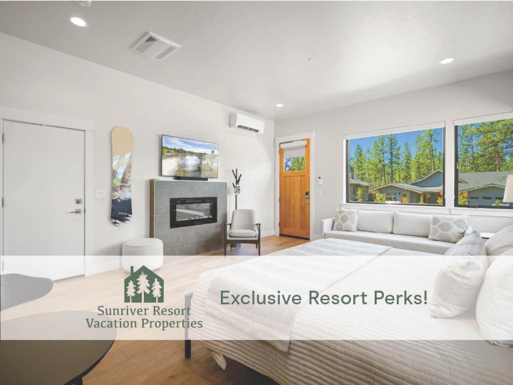 a bedroom with a large bed and a fireplace at 18112-2 Forestbrook Loop in Bend