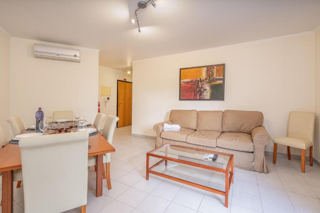 a living room with a couch and a table at Cool Motion Rocha Beach T2 in Portimão