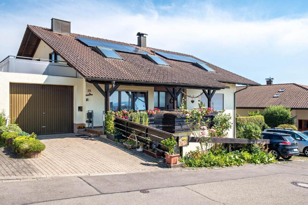 a house with a garage and a driveway at Gästehaus Gaby in Bad Bellingen
