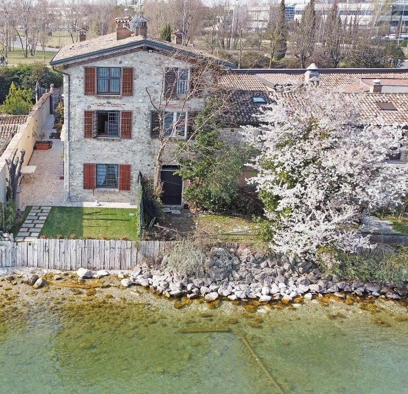 an aerial view of a house next to a body of water at L'antica Lugana front lake in Sirmione