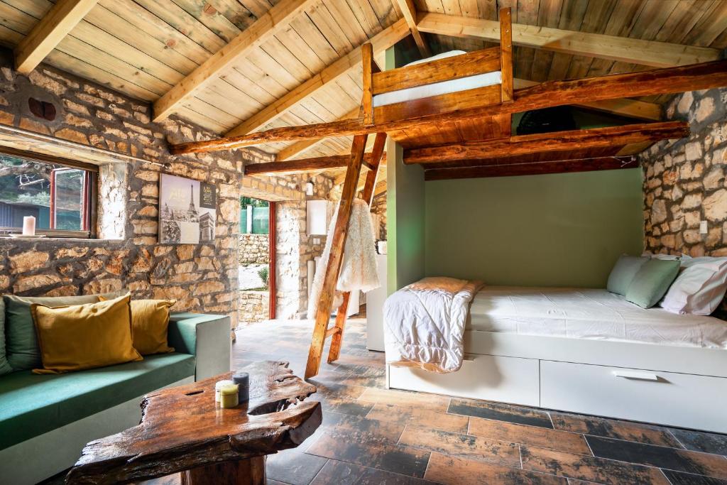 a room with a bed and a couch and a table at Villa Nikos in Kefallonia