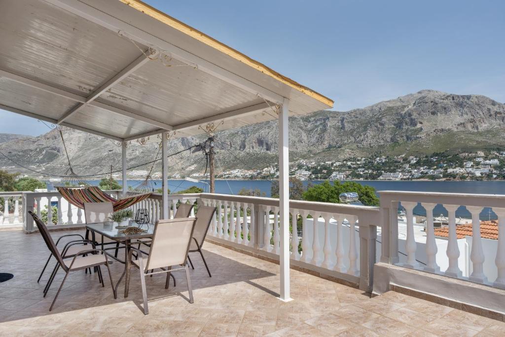 a patio with a table and chairs on a balcony at Studio Telendos in Telendos
