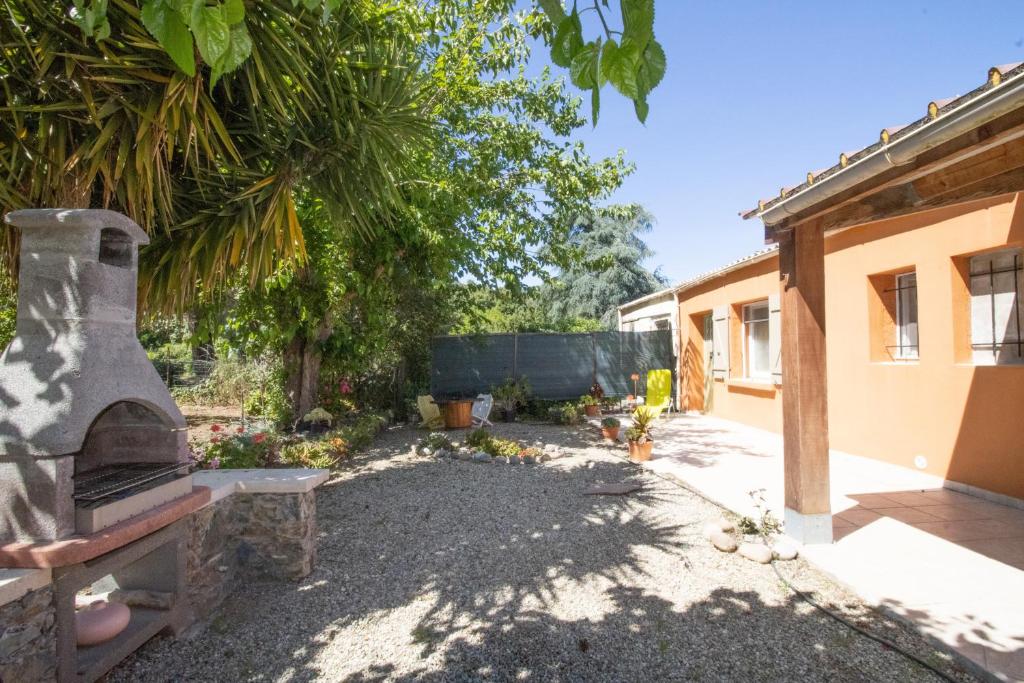 a garden with a stone fireplace next to a house at Isula Paradise in Linguizzetta