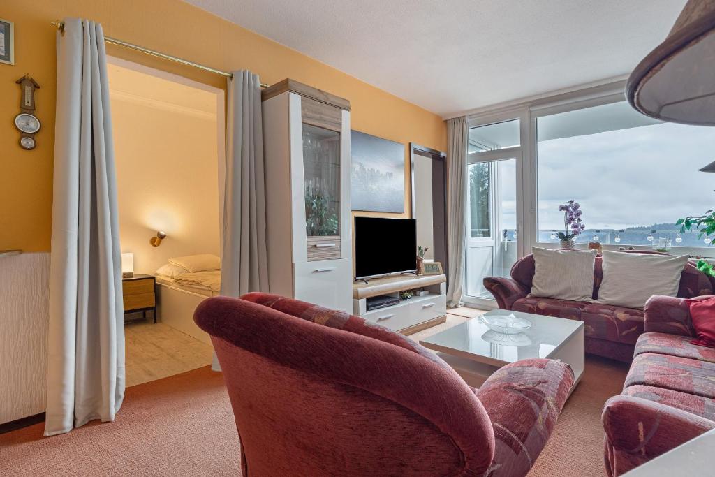 a living room with a couch and a tv at Harz Stube in Goslar