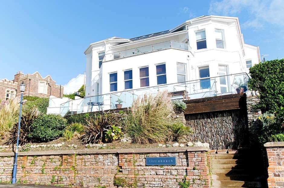 a white house on top of a brick wall at 6 Little Beach in Woolacombe