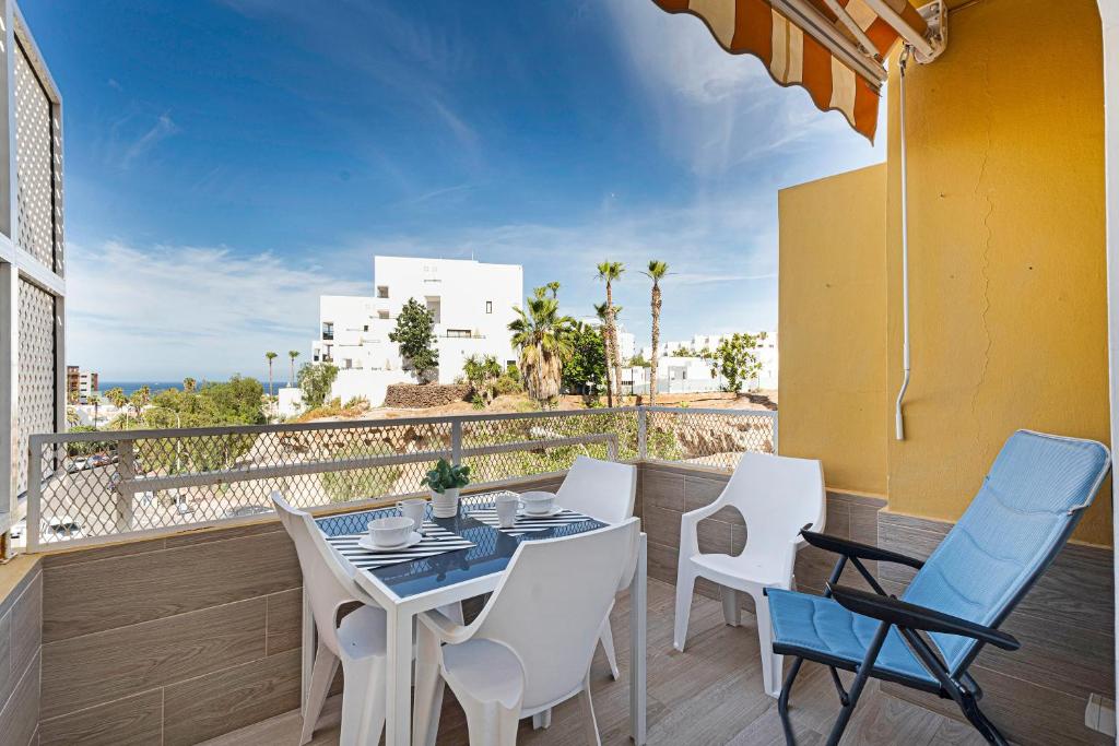 a patio with a table and chairs on a balcony at Orlando 314 in Adeje