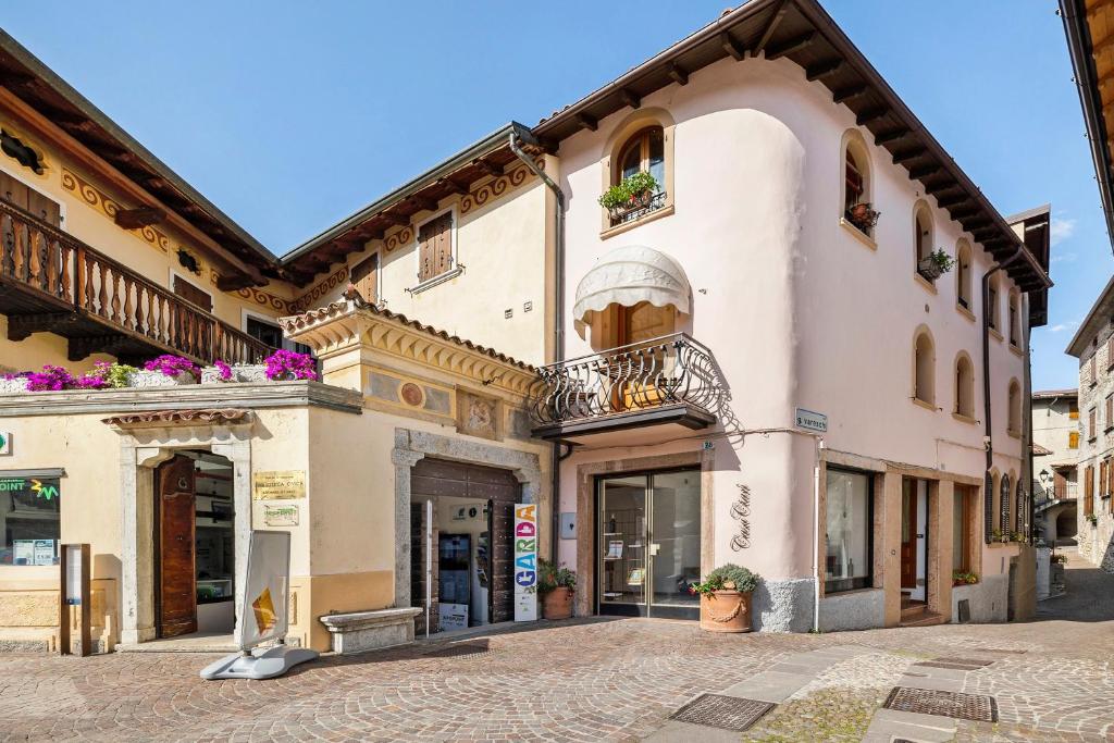 a building with flowers on the balconies on a street at Ciarii Holiday Homes in Tremosine Sul Garda