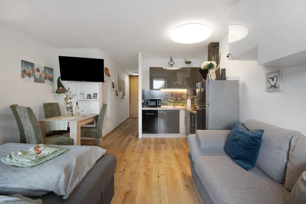 a living room with a couch and a table at Appartement Hella Wahnsinn in Sankt Englmar