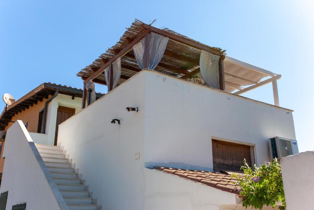 a white house with stairs on the side at Casa Euforbia in Orosei