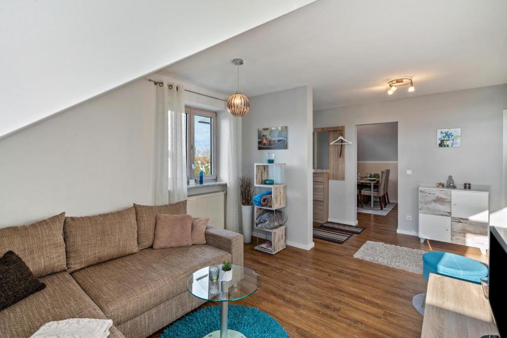 a living room with a couch and a table at Ferienwohnung Hobmaier in Forstern