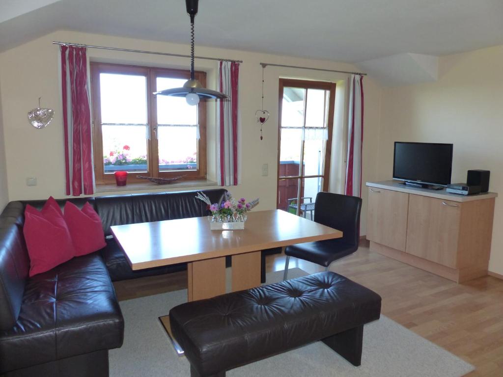 a living room with a table and a couch at Haus Schwärzler in Stiefenhofen