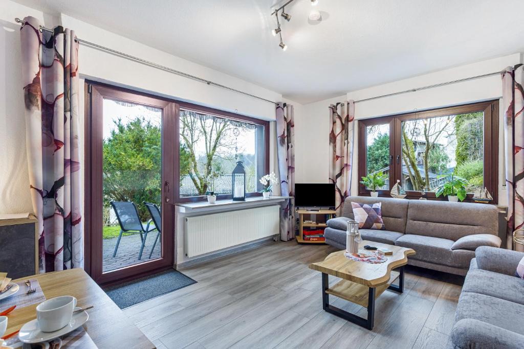 a living room with a couch and a table at Ferienwohnung Astrid in Sundern