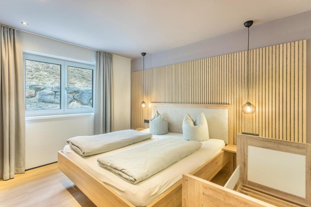 a bedroom with a bed and a window at Luisalle Top 2 in Auffach