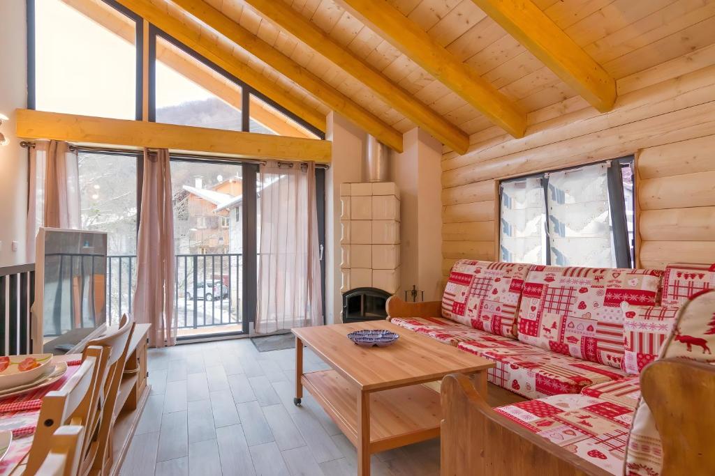 a living room with a couch and a table at Charming Chalet 3 étoiles - 10 pers in Courchevel