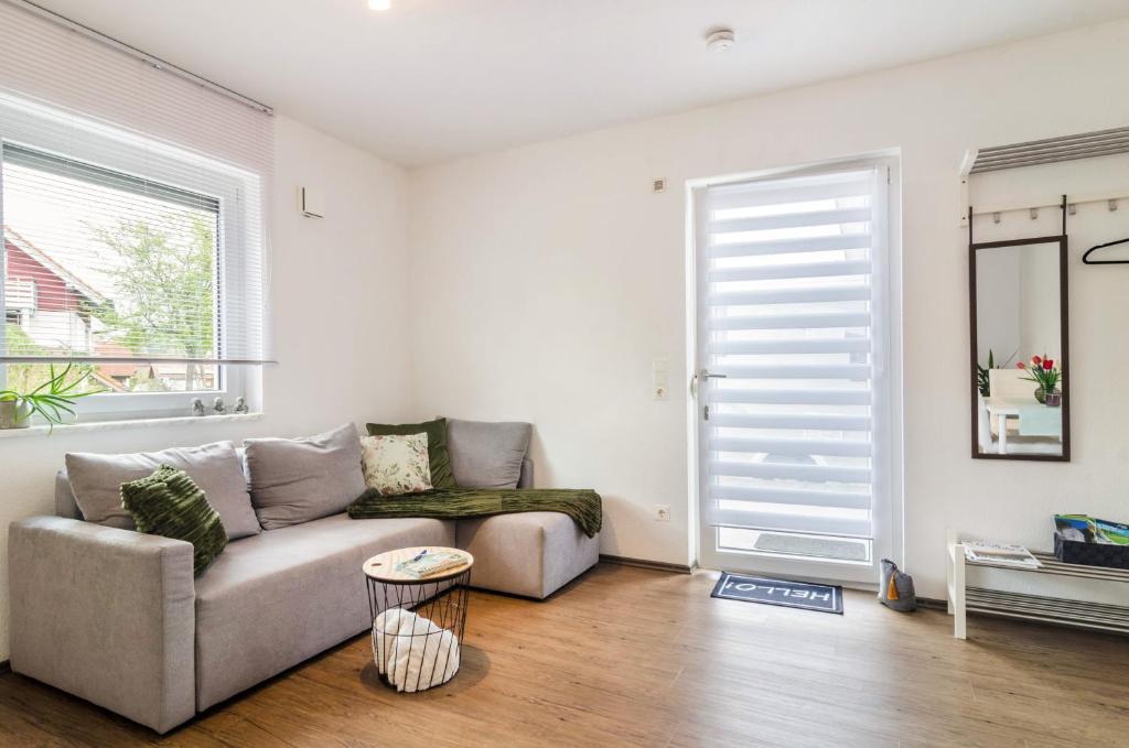 a living room with a couch and a window at Ferienwohnung Inzigkofen in Inzigkofen