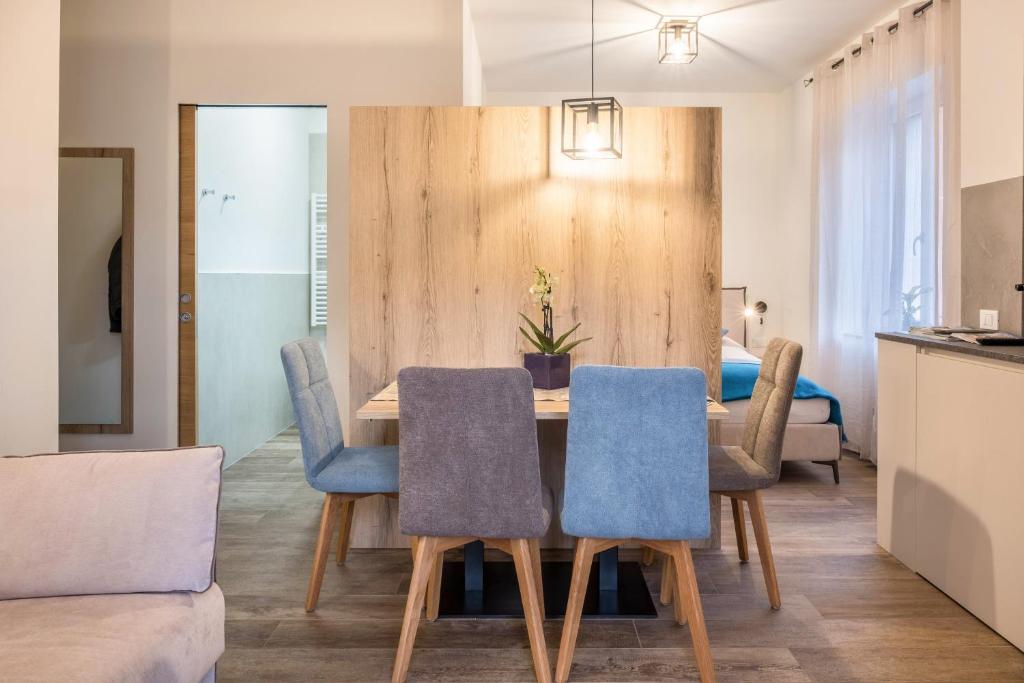 a dining room with a table and blue chairs at Apartment Annabel in Bolzano