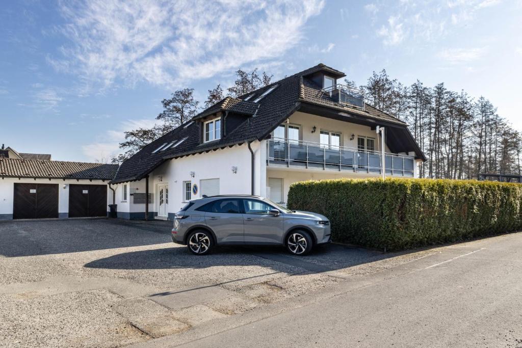 a car parked in front of a house at Haus am Eschenbach in Lindenberg