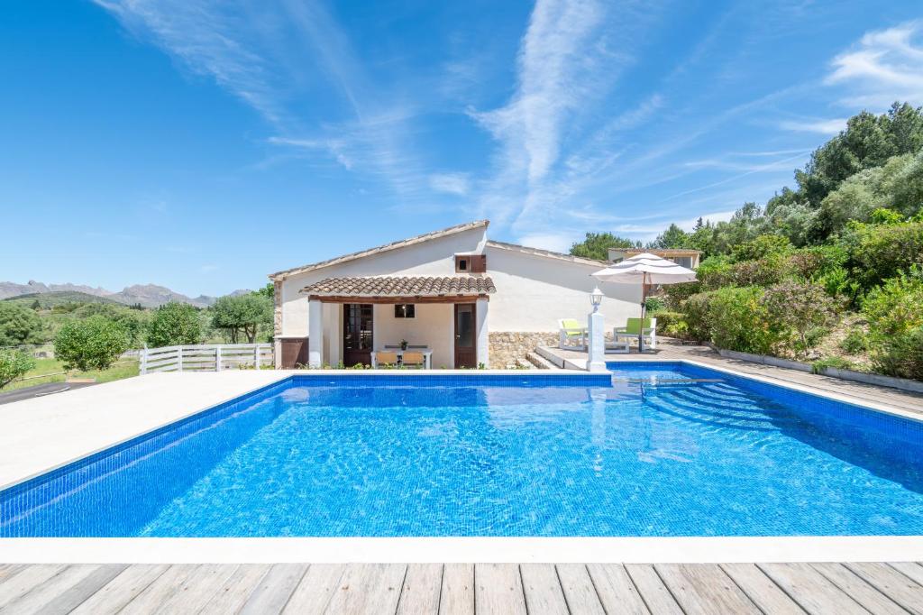 a villa with a swimming pool and a house at Can Negri - Almadraba in El Port