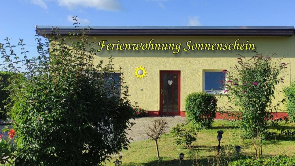 a building with a sign on the side of it at Ferienhaus Sonnenschein in Preetz