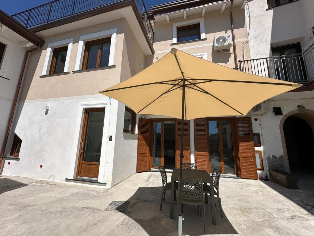 a chair and an umbrella in front of a building at Residence Sulla Costa in Agerola