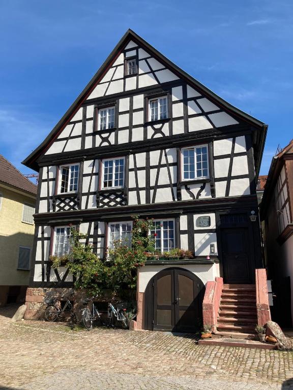a black and white building with bikes parked in front of it at Ferienwohnung Scheffelhaus in Gengenbach