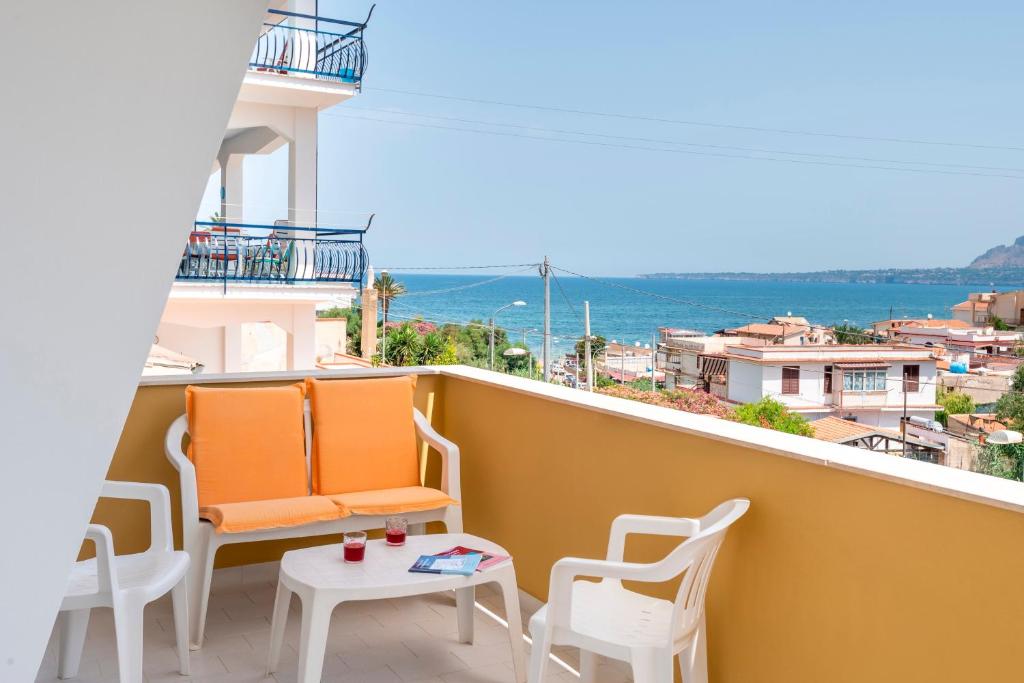 a balcony with chairs and a table with a view at Casa Viola 1 piano 100 mt dal mare in Trappeto