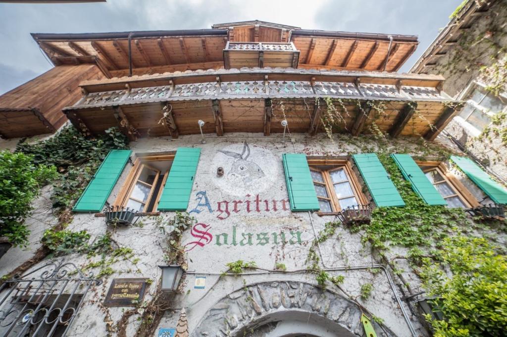 an old building with a sign on it at Agritur Solasna in Caldes