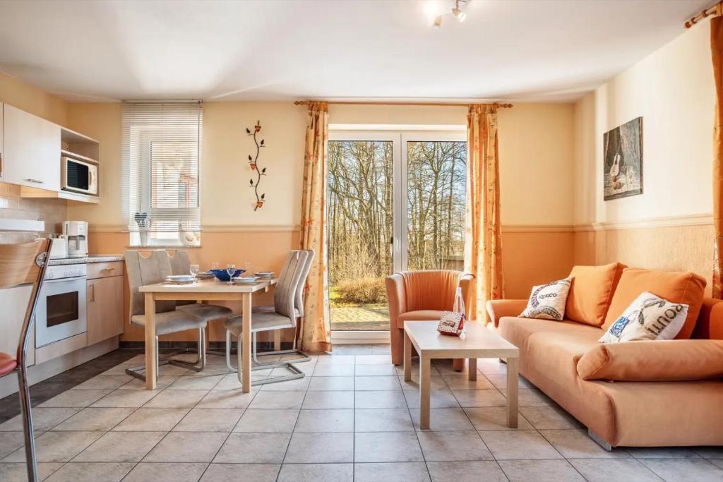 a living room with a couch and a table at Schwalbennest in Buschvitz