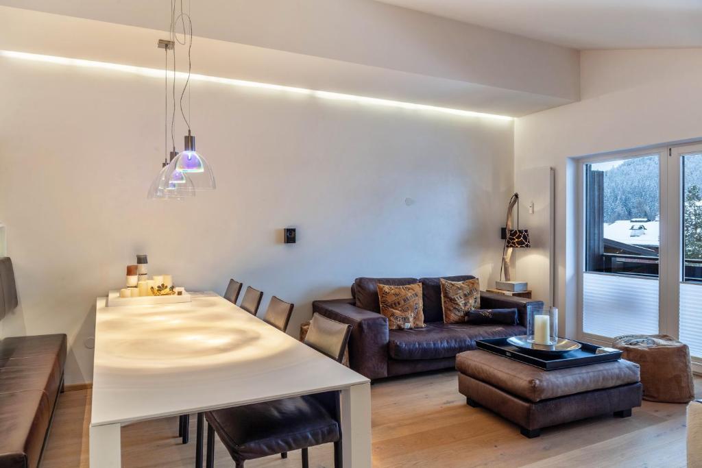 a living room with a table and a couch at Haus Excelsior Top 38 in Seefeld in Tirol