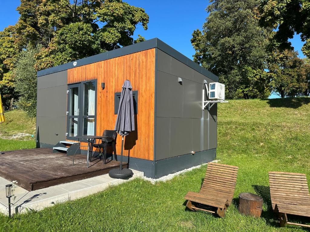 a small shed with a table and an umbrella at Haus Laura in Untergriesbach