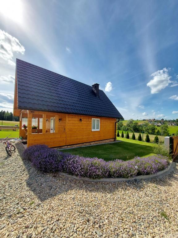 a house with a black roof on a gravel yard at Dolina Skawy in Skawa