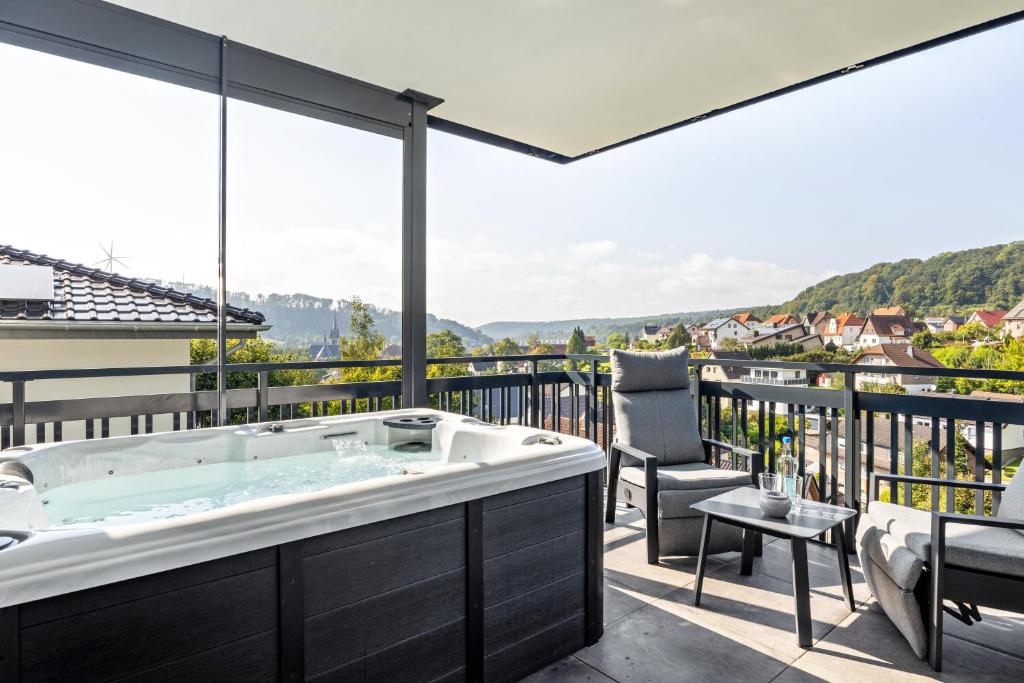 a bath tub on the balcony of a house at Egge Resort 7c mit Whirpool u Sauna in Altenbeken