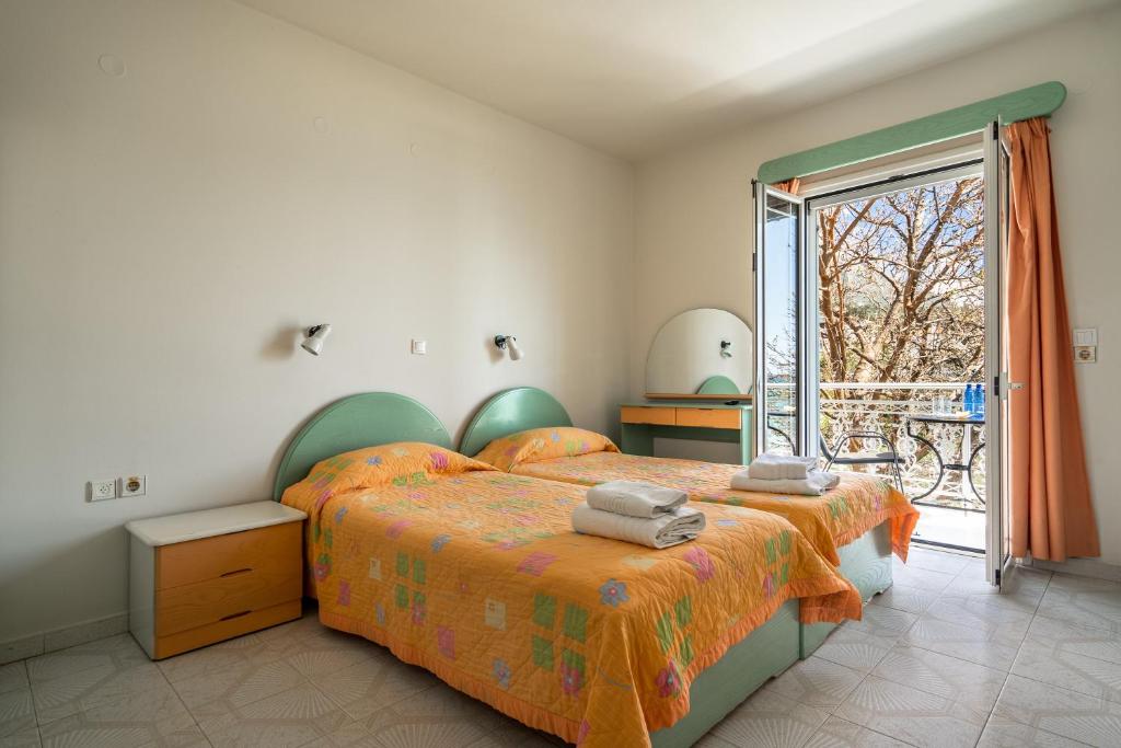 a bedroom with a bed and a large window at Angela partial sea view 8 in Kefallonia