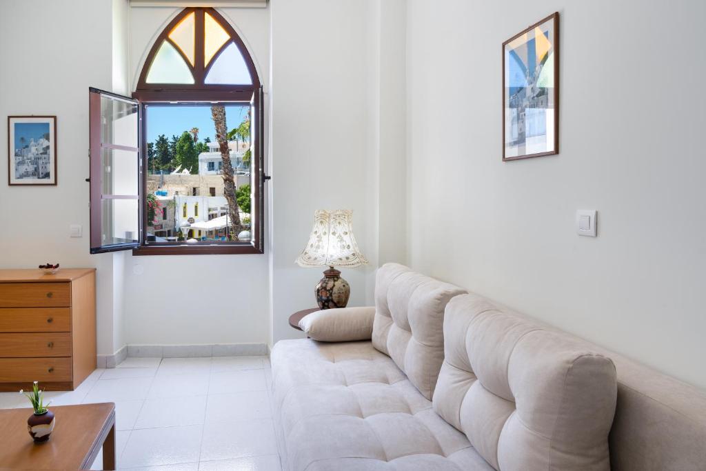 a living room with a couch and a window at Port House in Kos