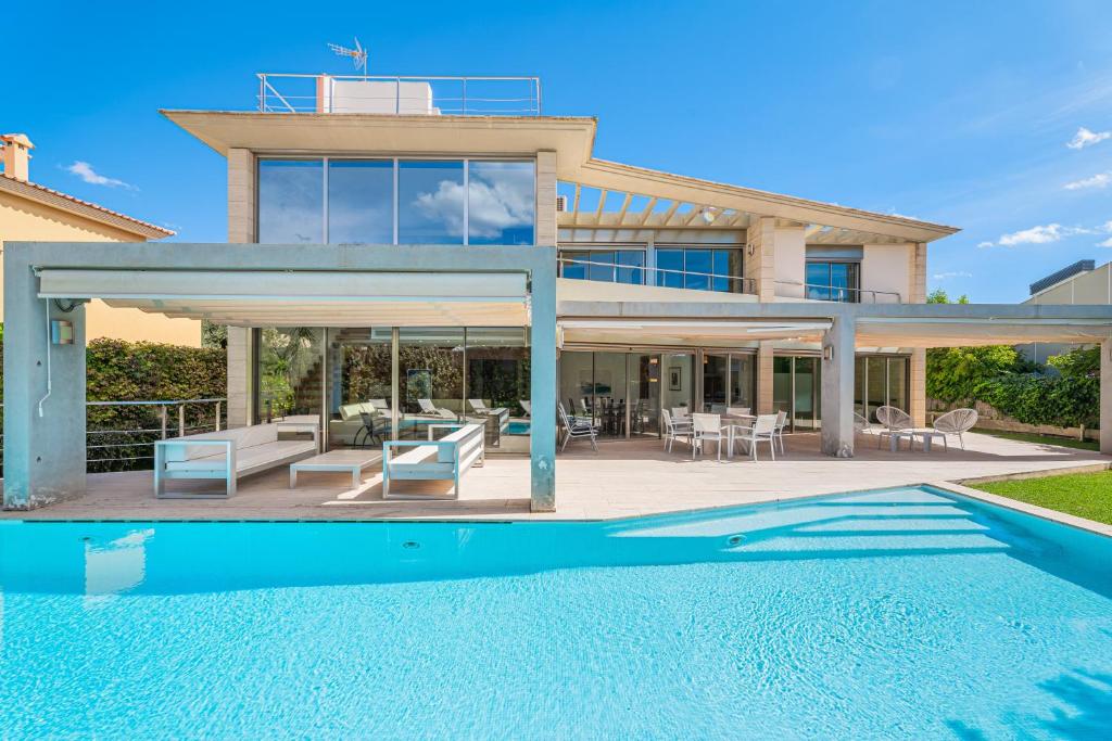 a villa with a swimming pool and a house at Villa Agusmar in Llucmajor