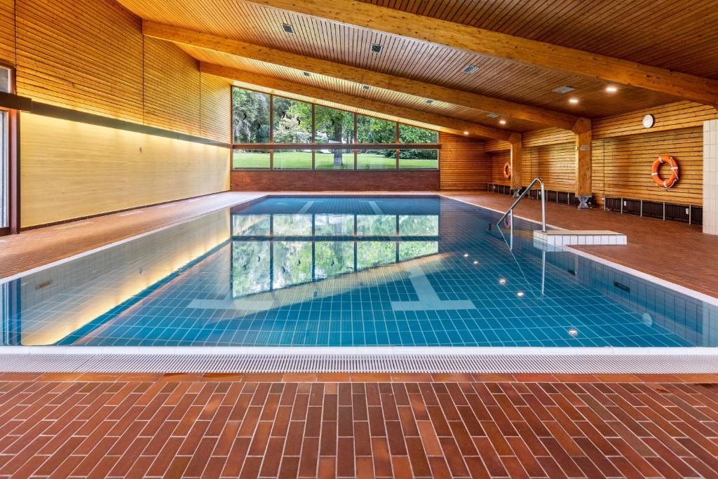 a swimming pool in a house with a ceiling at Ferienwohnung Fetscher 2 in Reichenau