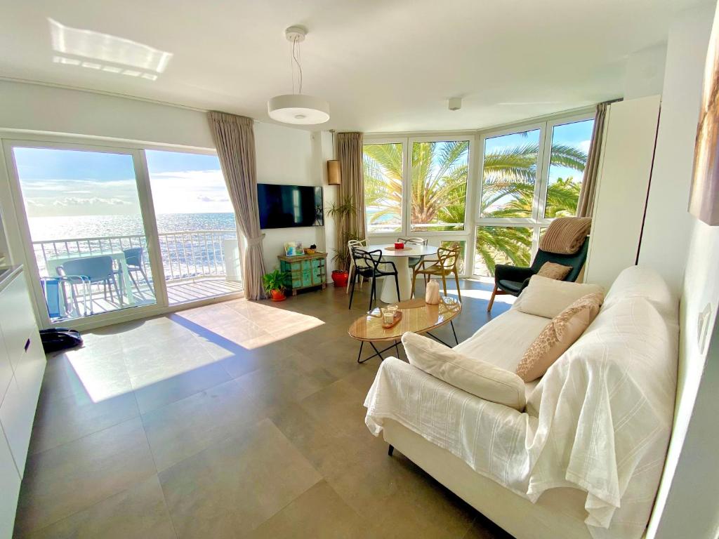 a living room with a couch and a view of the ocean at Super Front Line Modern New Apartm in Nerja