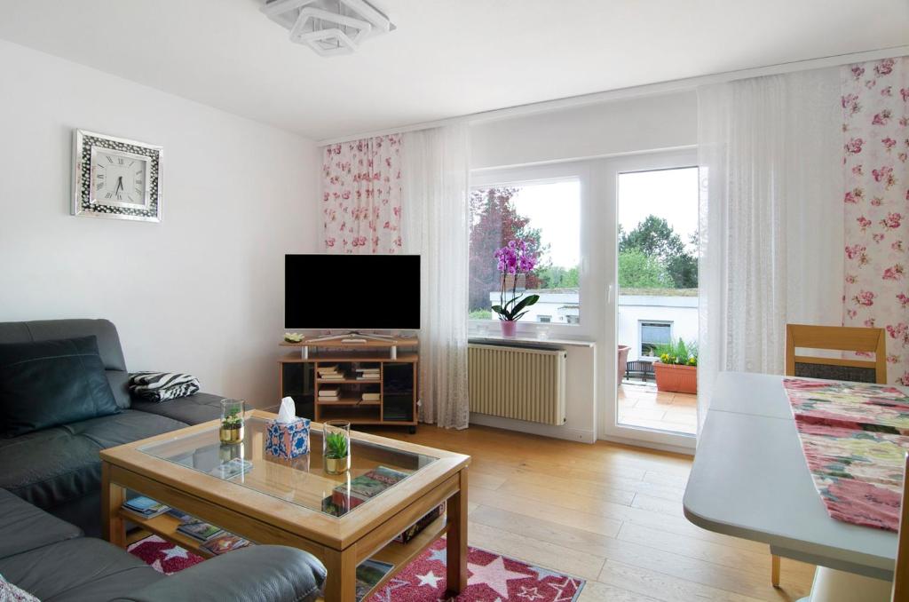 a living room with a couch and a tv at Aida in Überlingen